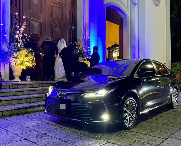 Carro executivo Toyota Corolla na porta da igreja em casamento, transporte de noivos